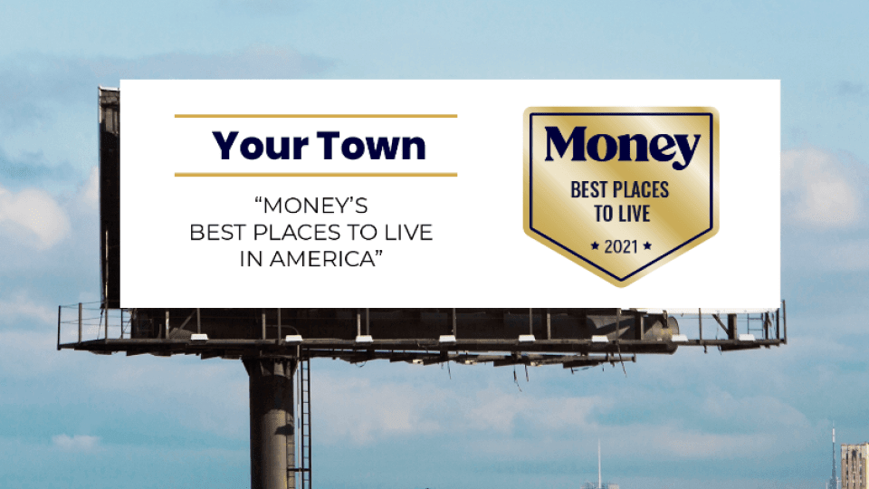 A highway billboard sign promoting the virtues of the next town is enhanced by a prominent Money Best Places to Live award logo.